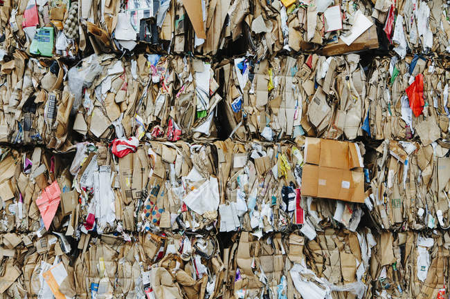Recycling facility with bundles of cardboard sorted and tied up for recycling. — Stock Photo