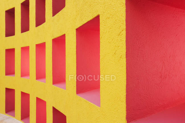 Niches in yellow and red modern wall, full frame — Stock Photo
