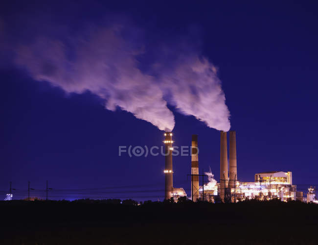 Smokestacks billowing smoke at night in industrial plant at Apollo Beach, Florida, USA — Stock Photo