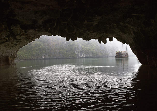 Chinese junk seen through cave entrance, Halong Bay, Quang Ninh, Vietnam — Stock Photo