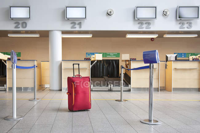 Suitcase at airport check-in counter of Tallinn airport, Estonia — Stock Photo