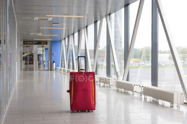 Suitcase in empty airport corridor of Tallinn airport, Estonia — Stock Photo