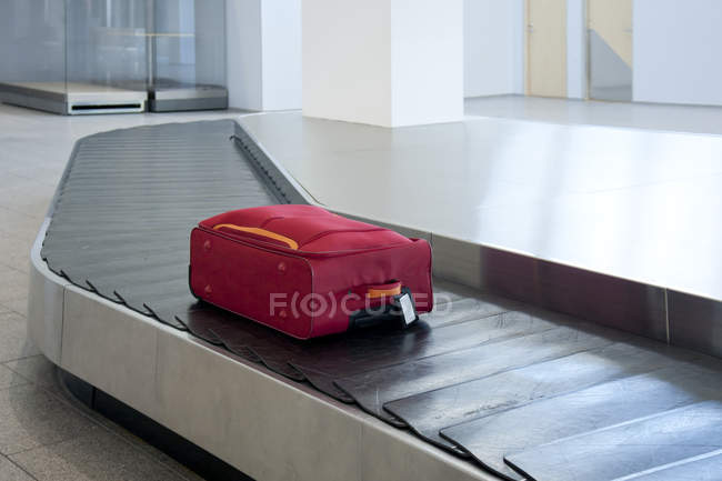Suitcase on airport conveyor belt of Tallinn airport, Estonia — Stock Photo