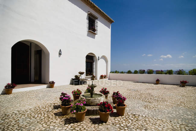 Flowerpots em torno de fonte fora villa, Andaluzia, Espanha — Fotografia de Stock