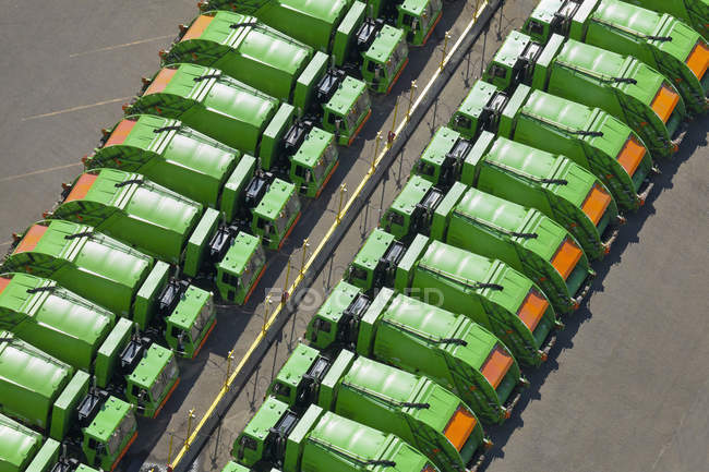 Aerial view of green garbage trucks in rows in parking lot — Stock Photo