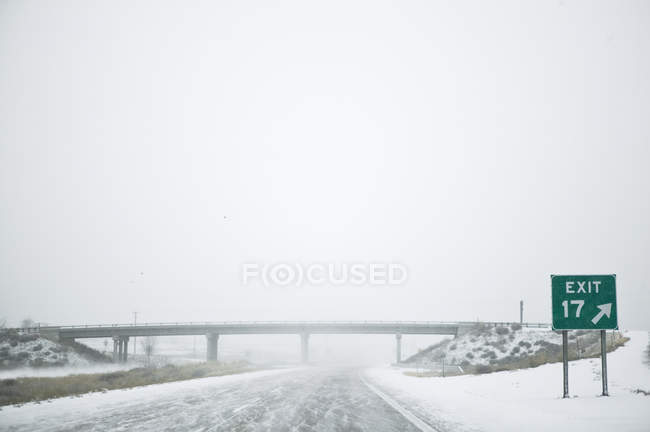 Snowy highway with road sign, Idaho, USA — Stock Photo