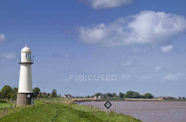 Lighthouse by grassy shore with sign, Whitgift, England, Great Britain, Europe — Stock Photo