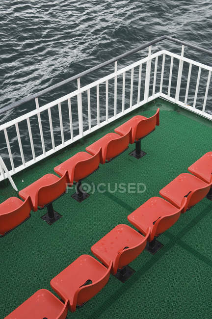 Orangefarbene Stuhlreihen auf grünem Teppich auf der Fähre, quer durch die Grafschaft, Schottland, Großbritannien — Stockfoto