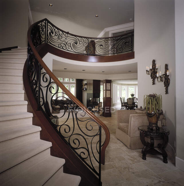 Staircase with ornate handrail pattern in luxury house — Stock Photo