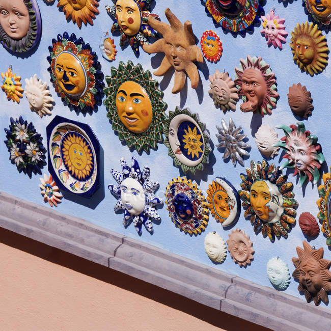 Close-up of sun and moon ornaments on wall — Stock Photo