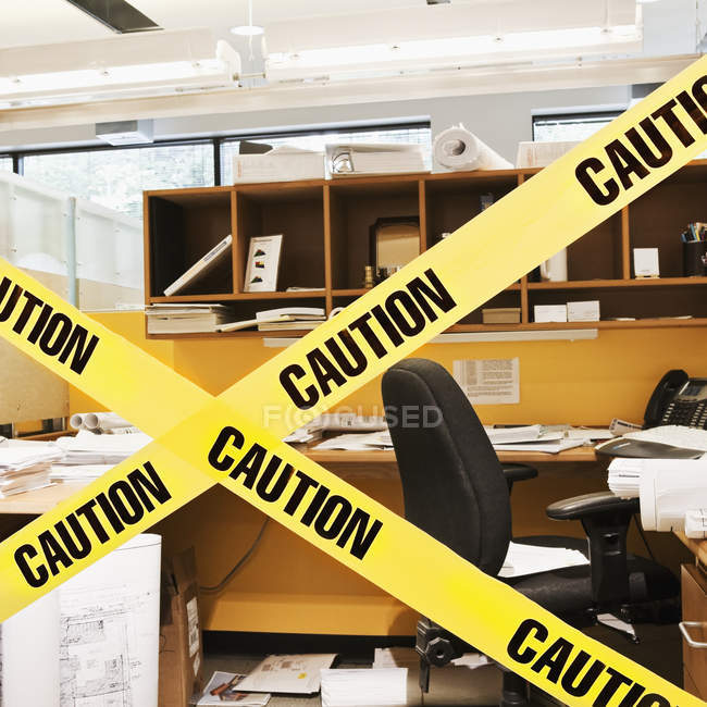 Close-up of caution tape blocking cubicle entrance — Stock Photo