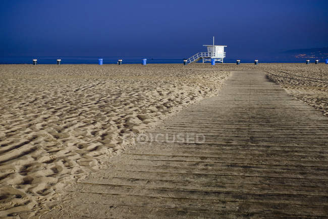 Path on sandy beach with lifeguard in California, USA — Stock Photo