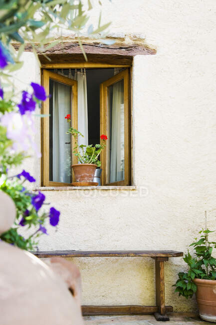 Open Window With Potted Plants and Bench — Stock Photo