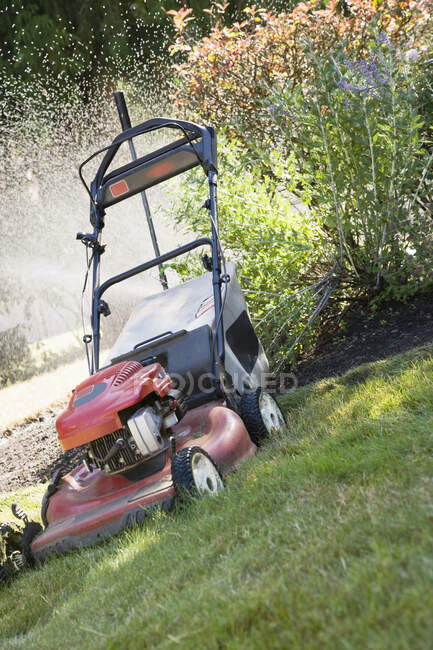 Lawn mower on green grass — Stock Photo