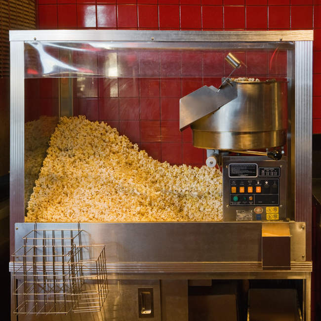 Commercial popcorn machine producing fresh snack — Stock Photo