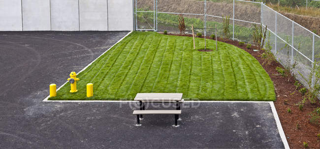 Small athletic field with bench and fence in elementary school — Stock Photo