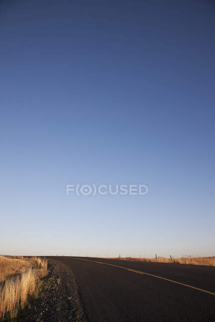 Two lane highway road in country field — Stock Photo