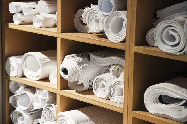 Rolls of blueprints in cubbyholes in office, close-up — Stock Photo