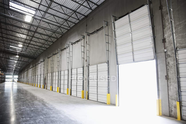 Open door at loading dock in warehouse — Stock Photo