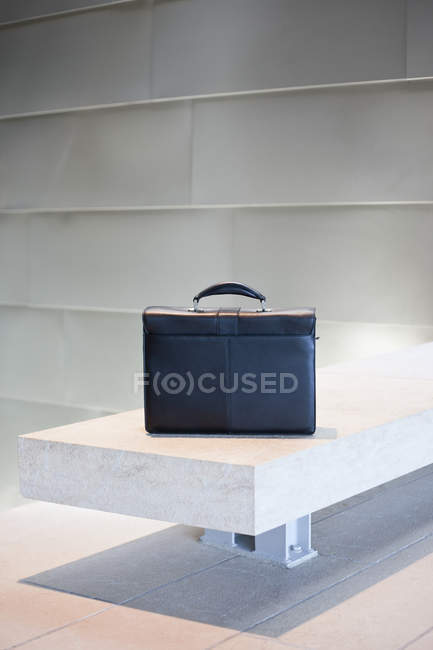 Black briefcase on white stone bench in Seattle, Washington, USA — Stock Photo