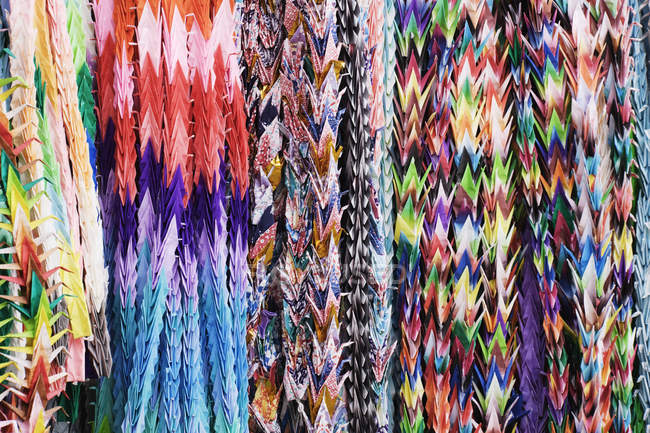 Colorful origami cranes at souvenir stall, full frame — Stock Photo