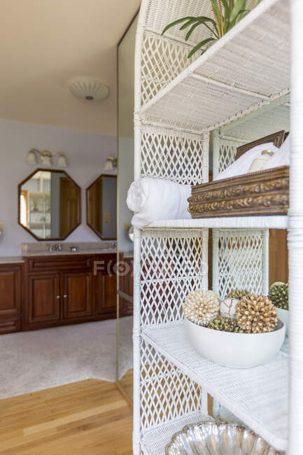 Wicker shelves outside bathroom — Stock Photo