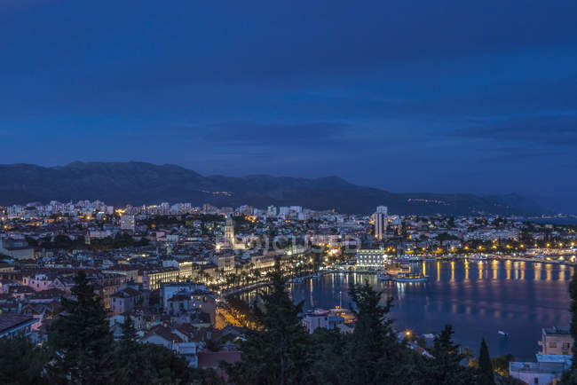 Vista aérea del muelle iluminado y paisaje urbano de la ciudad costera, Split, Croacia - foto de stock