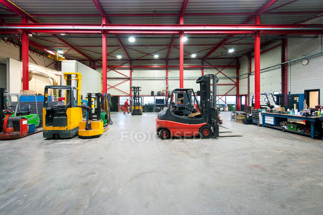 Forklift machinery working in warehouse interior — Stock Photo