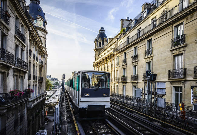 Streetcar passing between apartment buildings, Paris, France — Stock Photo