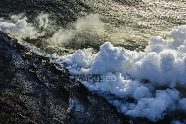 Дым от лавы рядом с океанской водой, вид с воздуха, Гавайи, США — стоковое фото