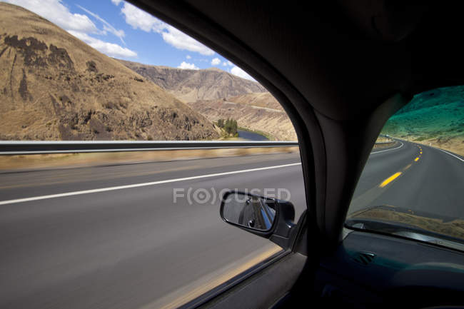 Автомобиль едет по дороге через Якима Ривер Каньон, Вашингтон, США — стоковое фото