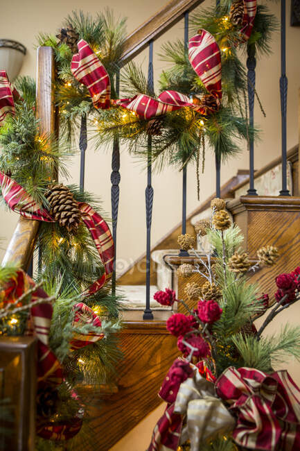 Banister decorated with boughs and string lights for Christmas — Stock Photo