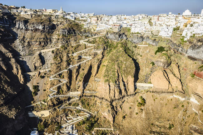 Вид с воздуха на город, построенный на скалистом побережье, Ойя, Эгео, Греция — стоковое фото