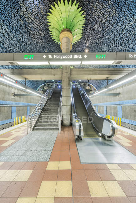 Ornate pillars, escalator and movie reels on ceiling in subway station, Los Angeles, California, United States — Stock Photo