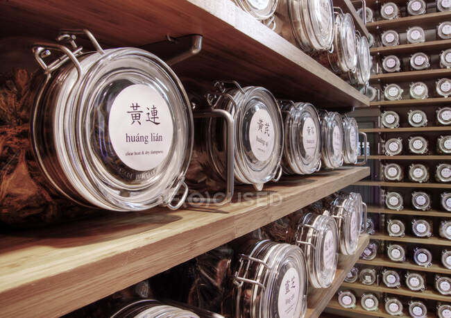 Close up of dried tea in jars on shelves — Stock Photo