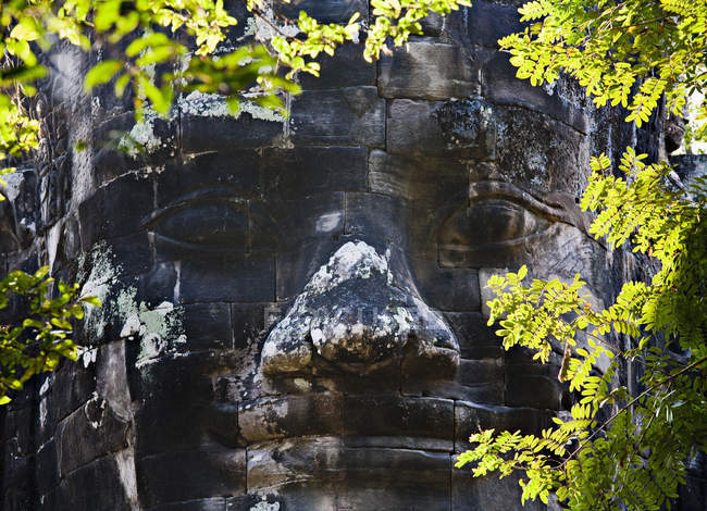 Carved stone face, Angkor, Cambodia — Stock Photo
