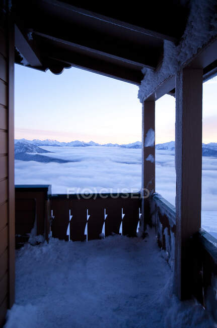 Porche cubierto de nieve con vistas al paisaje remoto - foto de stock