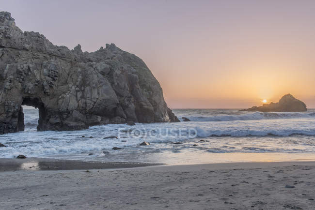 Ondas a lavar-se na praia rochosa ao pôr-do-sol, Califórnia, EUA — Fotografia de Stock