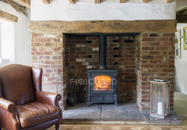 Armchair and fireplace in living room — Stock Photo