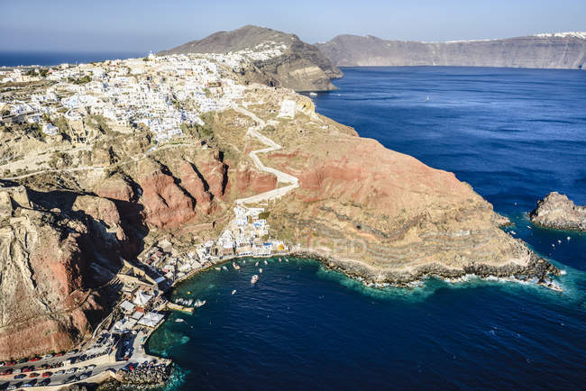 Vista aérea de la ciudad construida en la costa rocosa, Oia, Egeo, Grecia - foto de stock
