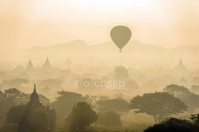 Aerial view of hot air balloon flying over ancient towers in Myanmar — Stock Photo