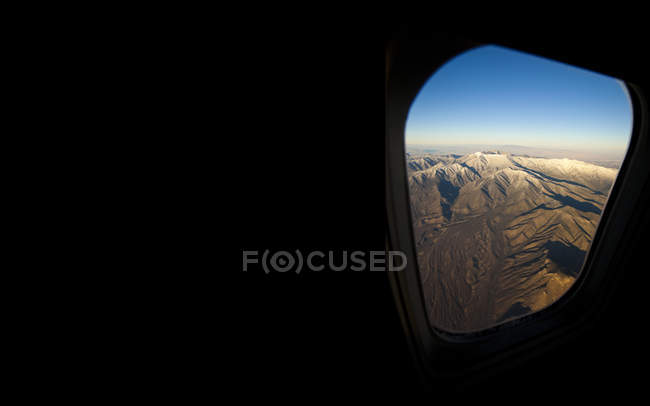 Rocky landscape viewed from airplane window — Stock Photo