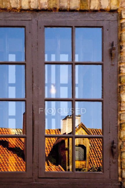 Rooftop reflected in windows, Malmo, Швеция — стоковое фото