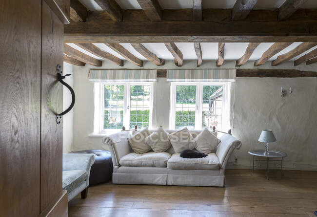 Sofa under beams in living room — Stock Photo
