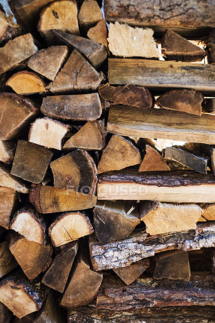 Full frame of rustic stacked firewood logs. — Stock Photo