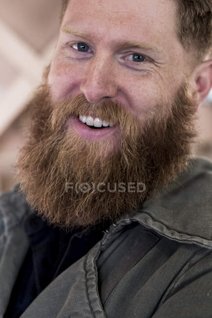 Retrato de hombre barbudo sonriente con cabello castaño . - foto de stock