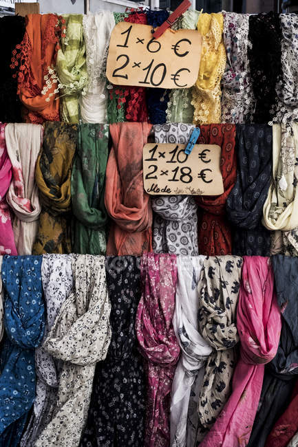 Primer plano de gran selección de bufandas de colores en el puesto de mercado . - foto de stock