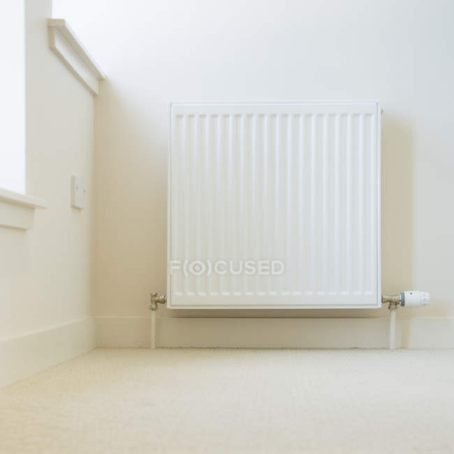 Radiator against white wall in modern building — Stock Photo