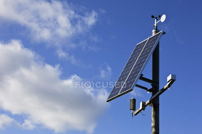 Solar panels against blue sky with white clouds — Stock Photo