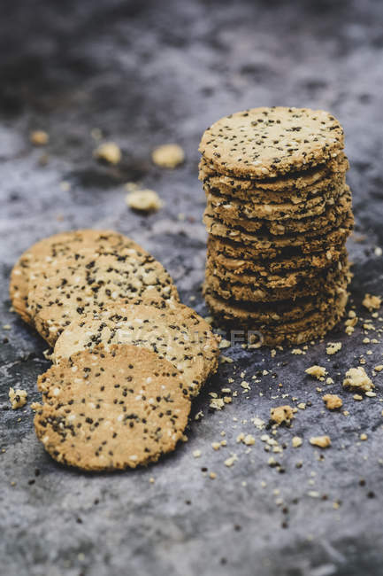 High angle close-up of stack of freshly baked seeded crackers. — Stock Photo